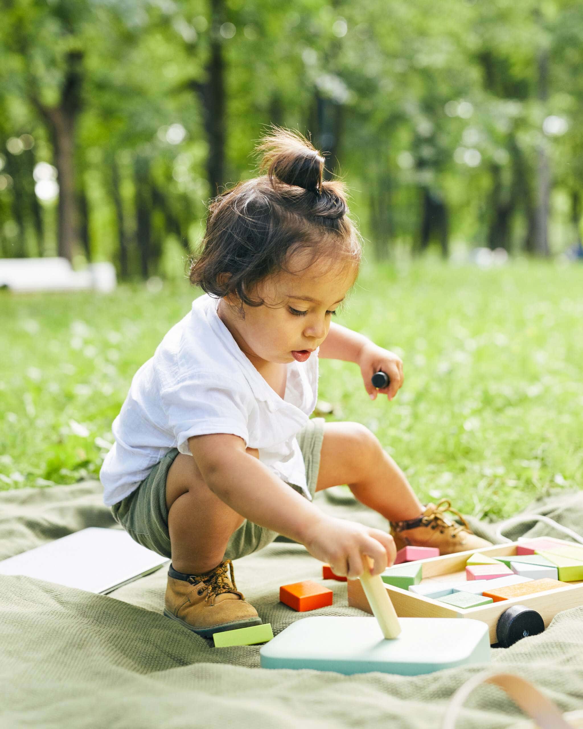 Toddler playing outdoors during a Parent and Me class