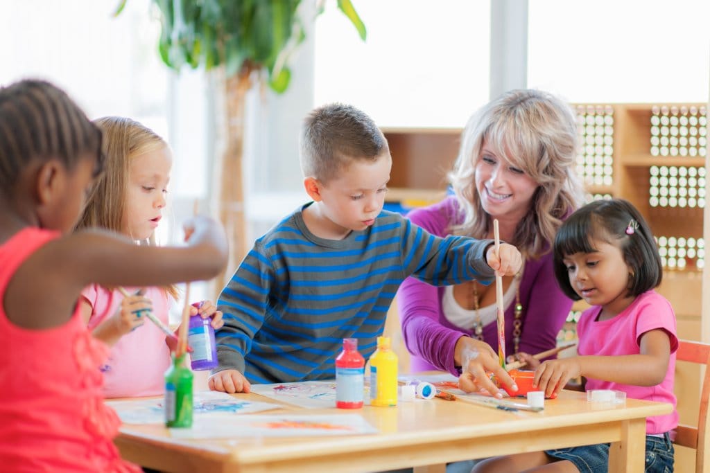 Primary students painting at desk Kindergarten students painting at a desk in an Early Childhood Education Primary classroom
