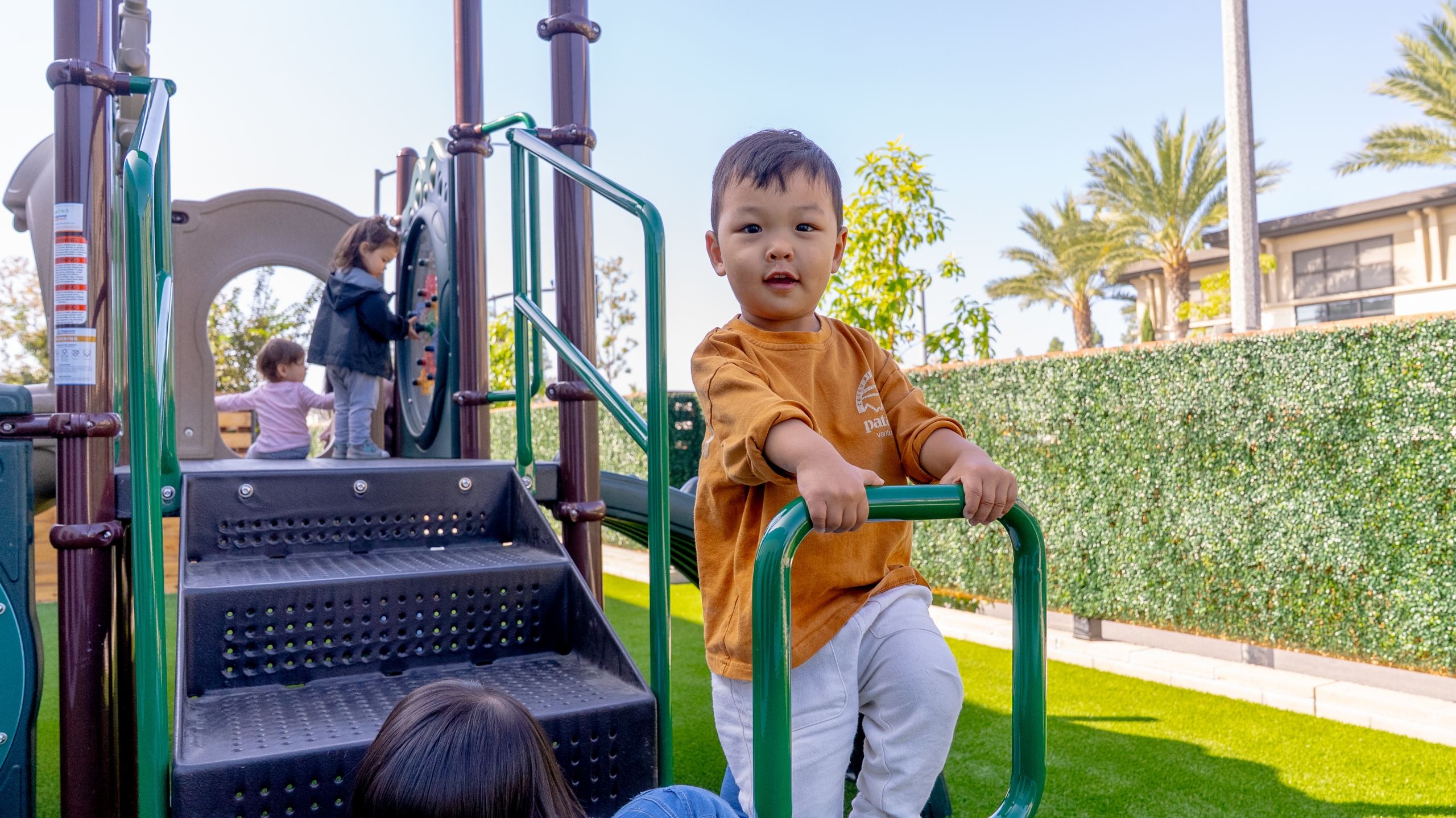 WELA Open House, December: December Around the World: A Cultural Mini Fair. A boy at the playground.