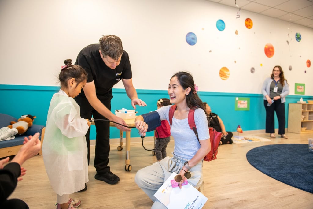 Young children testing floating and sinking objects during STEAM activity at Irvine preschool